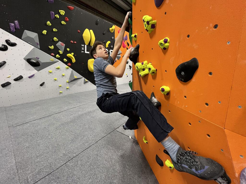 Boy on rock climbing wall